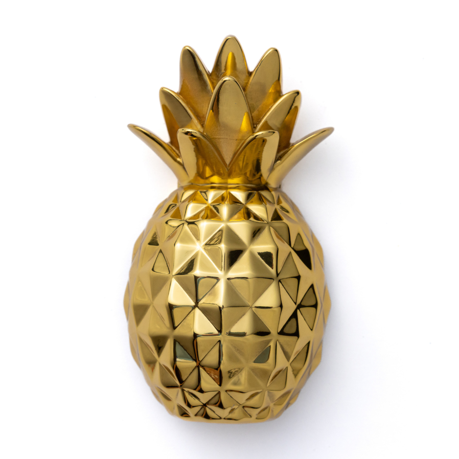 Gold pineapple decorative door knocker on a white background