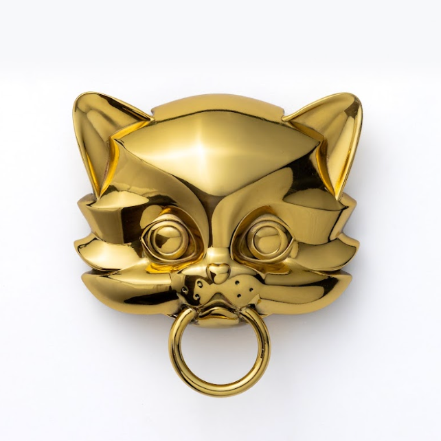 Gold Keen kitten door knocker on a white background