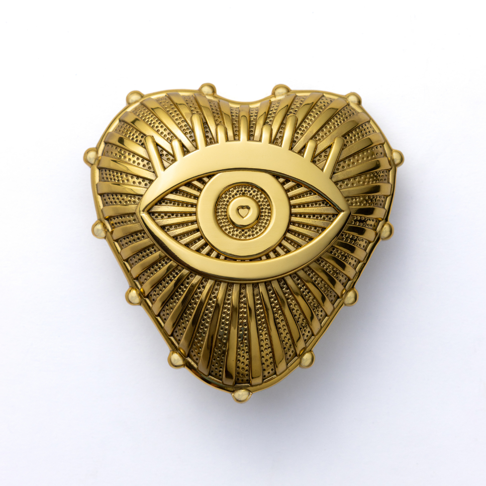 Gold decorative adored amulet door knocker on a white background